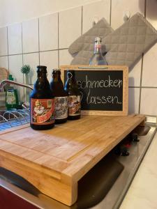 a counter with three bottles of beer on it at Ferienwohnung am Waldrand in Tharandt