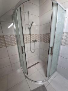 a shower with a glass door in a bathroom at Areál Bobo 