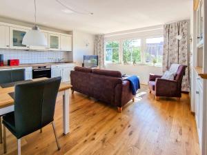 a living room with two couches and a table at Steuerbord in Greetsiel