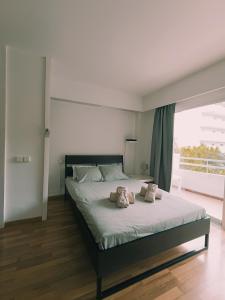 a bedroom with a bed with two stuffed animals on it at Piso moderno con piscina Siesta 2 in Port d'Alcudia