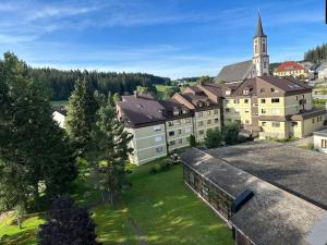 an aerial view of a large building with a church at Ruhige Ferienwohnung in Schönwald in Schönwald