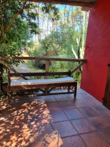 a bench sitting on the porch of a house at Casa bosque y mar in Ocean Park
