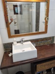 a bathroom with a white sink and a mirror at Casa bosque y mar in Ocean Park +16 photos
