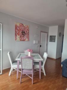 a dining room with a table and chairs at Sol y Luz in Isla del Moral