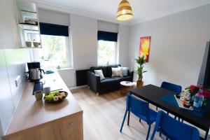 a kitchen and a living room with a table at BetterBeds Gelsenkirchen in Gelsenkirchen