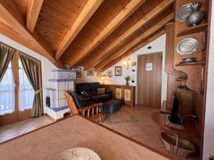 a living room with wooden ceilings and a couch at Residenza Arcadia in Giustino +11 photos