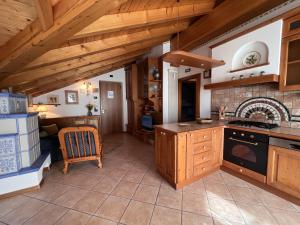 Residenza Arcadia في Giustino: مطبخ بدولاب خشبي وفرن علوي موقد