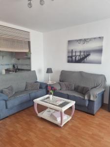 a living room with two couches and a coffee table at Sol y Luz in Isla del Moral