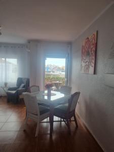 a living room with a table and chairs and a couch at Sol y Luz in Isla del Moral