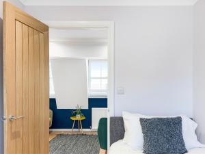 a bedroom with a bed and a wooden door at Serene 2BR Retreat in Bishop's Stortford in Bishops Stortford