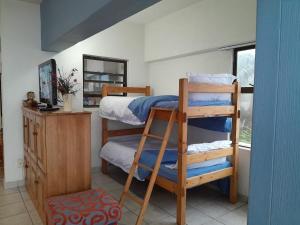 a bedroom with two bunk beds and a mirror at No. 3 Crow's nest in Margate