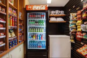 a refrigerator filled with lots of drinks in a store at Days Inn by Wyndham Medicine Hat in Medicine Hat