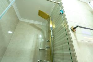 a shower with a glass door in a bathroom at Laura Residence in Bouznika +43 photos