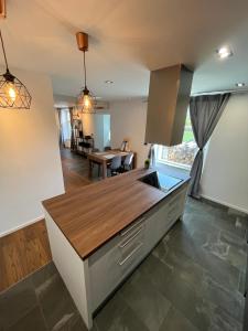 eine Küche mit einer Holzarbeitsplatte und einem Tisch in der Unterkunft Apartment Bacci in Vrhnika