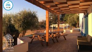 a wooden pergola with a picnic table on a patio at Almojanda 3 olive tree in Fortios