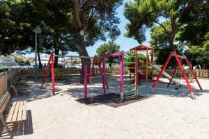 a park with a playground with a slide at Guest House Dada in Dubrovnik