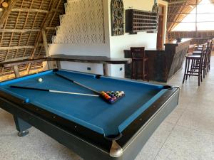 a pool table with a ball in a room at Zi Villa Garden Room 1 in Matemwe