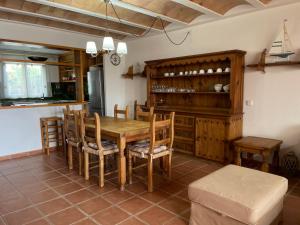 ein Esszimmer mit einem Holztisch und Stühlen in der Unterkunft ES BERRY 3 by SOM Menorca in Fornells