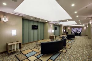 a lobby with a waiting room with chairs and tables at Hampton By Hilton Gaziantep in Gaziantep