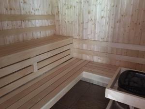 a small wooden sauna with a bench in it at Bovisand Lodge Holiday Park in Plymouth