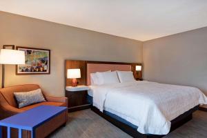 ein Hotelzimmer mit einem Bett und einem Stuhl in der Unterkunft Hampton Inn & Suites Rohnert Park - Sonoma County in Rohnert Park