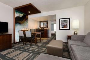 a living room with a couch and a dining room at Embassy Suites by Hilton Orlando International Drive Convention Center in Orlando
