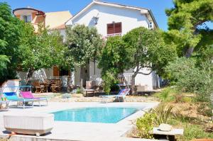 a villa with a swimming pool and a house at Villa Barbat 28 in Barbat na Rabu