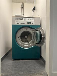 a washing machine with a camera on top of it at Hostel by Bromma in Stockholm