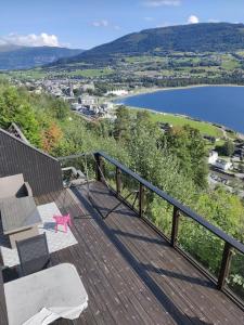 a balcony with a bench and a view of a lake at Modern family home in Voss in Vossevangen