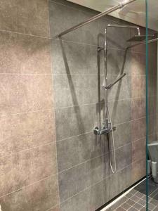 a shower with a glass door in a bathroom at Modern family home in Voss in Vossevangen