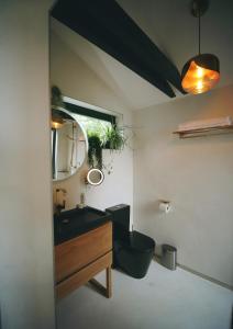 a bathroom with a black sink and a mirror at NavaGarden-panorama rest and spa in Balatonkenese