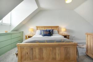 a bedroom with a large wooden bed in a attic at Exquisite & Relaxing Haven in Elton Lane, Sleeps 4 in Stockton-on-Tees