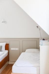 a bedroom with a white bed and a white ceiling at Backhaus Efringen-Kirchen in Efringen-Kirchen