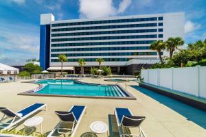 a hotel pool with chairs and a building at Hilton Ocala in Ocala