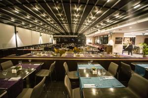 a restaurant with tables and chairs and a bar at Hilton Garden Inn Eskisehir in Eskisehir