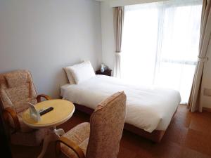Letto o letti in una camera di BiBi Hotel Cosmos Shintoshin