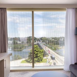 a room with a large window with a view at Hilton Garden Inn Tours Centre, France in Tours