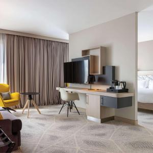 a hotel room with a desk and a bed at Hilton Garden Inn Tours Centre, France in Tours