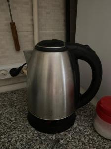 a black and silver tea kettle on a counter at Квартира на Проспекті in Uzhhorod