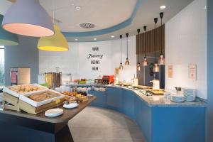 una cocina con una barra con un buffet de comida en Hampton by Hilton Krakow Airport en Balice