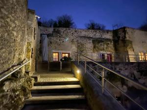 a set of stairs leading to a building at night at Gîte troglodyte 2 personnes in Azay-le-Rideau