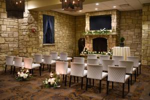 a room with a table and chairs and a fireplace at The Oread Lawrence, Tapestry Collection by Hilton in Lawrence