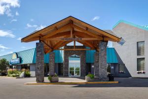 a building with awning in front of a store at Days Inn & Conference Centre by Wyndham Prince Albert in Prince Albert