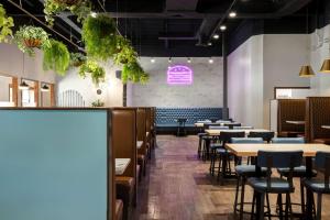 a row of tables and chairs in a restaurant at Days Inn & Conference Centre by Wyndham Prince Albert in Prince Albert