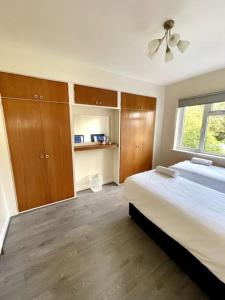 a bedroom with a large bed and a window at Stylish Four Bed City Retreat in Birmingham