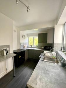 a kitchen with a sink and a counter top at Stylish Four Bed City Retreat in Birmingham