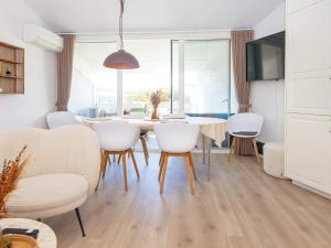 a dining room with a table and chairs at 8 person holiday home in Ringkøbing-By Traum in Ringkøbing