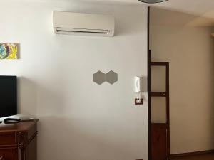 a room with a white wall with a air conditioner on it at Cattleya in Mola di Bari