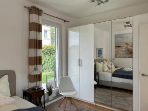 a bedroom with a sliding glass door leading to a bed at Strandperle Sonnenblick in Timmendorfer Strand