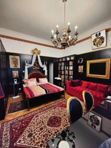 a bedroom with a red bed and a red couch at Luxury near Castle in Vienna